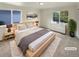 Serene bedroom featuring a comfortable bed, soft lighting, and large windows at 14822 E Adriatic Pl, Aurora, CO 80014