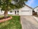 Charming home featuring a white facade, mature tree, and a two-car garage at 14822 E Adriatic Pl, Aurora, CO 80014