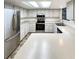 Well-lit kitchen with white cabinets, stainless steel appliances and solid surface countertops at 14822 E Adriatic Pl, Aurora, CO 80014