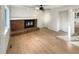 Bright living room features a brick fireplace, hardwood floors and a ceiling fan at 14822 E Adriatic Pl, Aurora, CO 80014