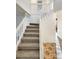 Elegant staircase with carpeted steps and tiled landing, leading to the upper level at 14822 E Adriatic Pl, Aurora, CO 80014