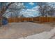 Gravel backyard area, ideal for parking, storage, or creating an outdoor living space, enclosed by a wooden fence at 5191 S Logan St, Littleton, CO 80121