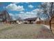 Spacious backyard featuring a detached shed, dog house, lush green grass, and a charming covered patio at 5191 S Logan St, Littleton, CO 80121