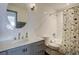 Modern bathroom with custom vanity and round mirror at 5191 S Logan St, Littleton, CO 80121