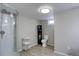 Functional bathroom featuring a shower, toilet, and shelving, enhanced with natural light from a window at 5191 S Logan St, Littleton, CO 80121