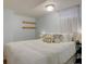Comfortable bedroom with natural light, floating wood shelves, and stylish decorative pillows at 5191 S Logan St, Littleton, CO 80121