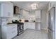 Bright kitchen features stainless steel appliances, white cabinets, subway tile backsplash, and hexagon tile floors at 5191 S Logan St, Littleton, CO 80121