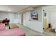 Spacious living area with a television, neutral walls, and a view into an adjacent bedroom at 5191 S Logan St, Littleton, CO 80121