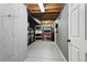 Basement with cement floor and block wall and shelving for storage at 17162 E Atlantic Pl, Aurora, CO 80013