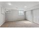 A finished carpeted basement with windows and closet space at 17162 E Atlantic Pl, Aurora, CO 80013