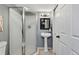 Modern bathroom with a glass shower, pedestal sink, and clean white door at 17162 E Atlantic Pl, Aurora, CO 80013