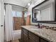 Bathroom with granite countertop, tub and shower with mosaic tile at 17162 E Atlantic Pl, Aurora, CO 80013