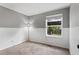 Bright bedroom with carpeted floors, wainscotting and a large window at 17162 E Atlantic Pl, Aurora, CO 80013