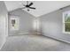 A spacious, carpeted bedroom with vaulted ceilings, ceiling fan and natural light from the windows at 17162 E Atlantic Pl, Aurora, CO 80013