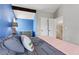 Bedroom with accent wall, beam feature, neutral carpet and large windows at 17162 E Atlantic Pl, Aurora, CO 80013