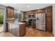 Well-lit kitchen featuring stainless steel appliances and dark stained cabinets at 17162 E Atlantic Pl, Aurora, CO 80013