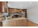 Well-lit kitchen featuring stainless steel appliances and dark stained cabinets at 17162 E Atlantic Pl, Aurora, CO 80013
