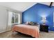 Main bedroom with a blue accent wall, neutral carpet and large windows at 17162 E Atlantic Pl, Aurora, CO 80013