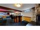 Basement bar area features bar seating, custom woodworking, a stone accent wall and an open floorplan at 4169 Hooker St, Denver, CO 80211