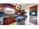 Well-equipped kitchen with dark wood cabinets, sleek black appliances, and tiled flooring, ideal for cooking enthusiasts at 4169 Hooker St, Denver, CO 80211