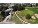 Aerial view of luxury home overlooking a golf course with mature trees and meticulously maintained landscaping at 6961 Salvia St, Arvada, CO 80007