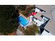 Aerial view showcasing a private backyard pool, lush landscaping, and the home's architectural design at 6961 Salvia St, Arvada, CO 80007