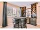 Home bar with seating, wooden wine rack, and shaker cabinets at 6961 Salvia St, Arvada, CO 80007