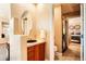 Bathroom with a wood vanity, vessel sink, and walk-in shower at 6961 Salvia St, Arvada, CO 80007