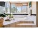 Luxury bathroom with a soaking tub, and large window with view at 6961 Salvia St, Arvada, CO 80007