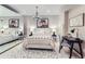 Well-lit bedroom featuring a chandelier, mirrored closet, and adjacent desk area at 6961 Salvia St, Arvada, CO 80007