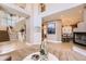 Spacious foyer with fireplace, staircase and views into kitchen at 6961 Salvia St, Arvada, CO 80007