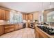 Well-lit kitchen with wooden cabinets, tile floors and stainless steel appliances at 6961 Salvia St, Arvada, CO 80007