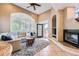 Cozy living room with fireplace, large windows, and access to outdoor space at 6961 Salvia St, Arvada, CO 80007