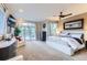 Bright main bedroom with a ceiling fan, balcony access, and neutral decor at 6961 Salvia St, Arvada, CO 80007
