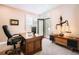 Bright home office with a wooden desk, and access to an outdoor balcony at 6961 Salvia St, Arvada, CO 80007
