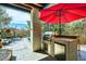 Outdoor kitchen featuring a built-in grill, fridge, and counter space, perfect for entertaining by the pool at 6961 Salvia St, Arvada, CO 80007