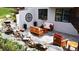 Inviting outdoor seating area with a charming water feature and comfortable wooden furniture with plush cushions at 6961 Salvia St, Arvada, CO 80007