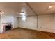 Unfinished basement room with brick fireplace and carpet at 2600 S Downing St, Denver, CO 80210