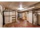 Unfinished basement area with shelving and water heater at 2600 S Downing St, Denver, CO 80210