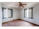 Simple bedroom with two windows, carpet, and ceiling fan at 2600 S Downing St, Denver, CO 80210