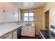 Kitchen features white cabinets, a sink, and a dishwasher at 2600 S Downing St, Denver, CO 80210