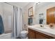 Bathroom featuring a shower with a curtain and a wood vanity cabinet with a white sink at 3079 E Long S Cir, Centennial, CO 80122