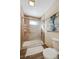 Bathroom featuring a shower with glass doors, tile surround, and a decorative painting at 3079 E Long S Cir, Centennial, CO 80122