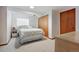 Cozy bedroom featuring soft carpet, a bed, closet with mirrored doors, and a bright window at 3079 E Long S Cir, Centennial, CO 80122