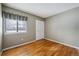 Empty bedroom showcasing hardwood floors, neutral walls, and a window providing natural light at 3079 E Long S Cir, Centennial, CO 80122