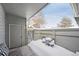 Cozy covered patio featuring outdoor furniture under a blanket of snow in a fenced in yard at 3079 E Long S Cir, Centennial, CO 80122