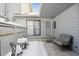 Inviting covered patio with outdoor seating, sliding glass door, and snow-covered ground at 3079 E Long S Cir, Centennial, CO 80122