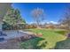 Large grassy backyard with a patio, a gazebo, and mature trees for shade at 1342 S Andes St, Aurora, CO 80017