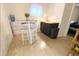 Finished basement area featuring light wood floors, a small bar, and a high-top table at 1342 S Andes St, Aurora, CO 80017