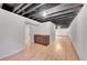 The basement has an exposed ceiling, light wood flooring, and built-in cabinets at 1342 S Andes St, Aurora, CO 80017